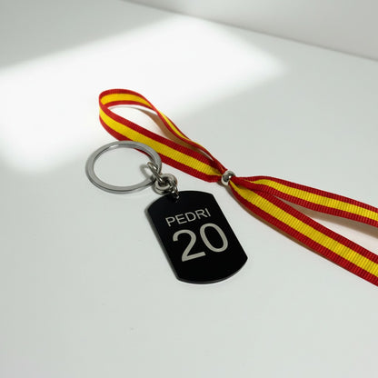 Llavero de color negro personalizable con dorsal y escudo de españa campeones del mundo por segunda vez. Dos estrellas. 